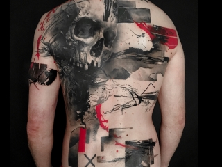 • Trash Polka tattoo on the back featuring a large skull and graphic elements